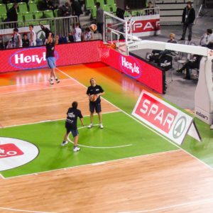Image shows digital screens surrounding basketball court