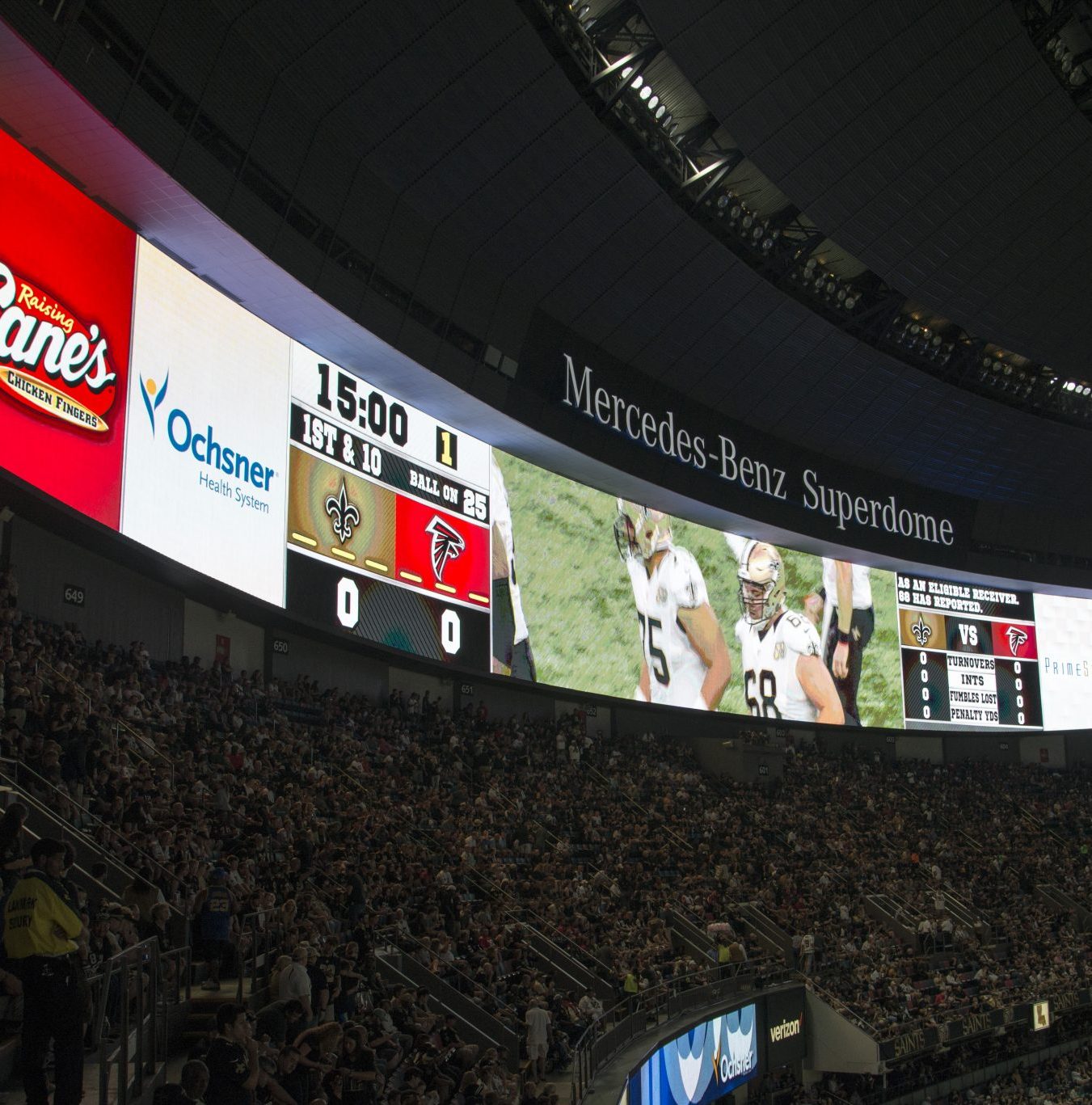 Image shows large digital screens wrapping around the inside of a sport stadium tier