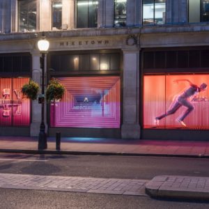 Image shows window display screens inside a Nike store.