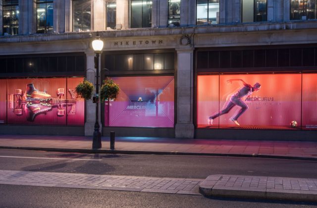 Image shows window display screens inside a Nike store.