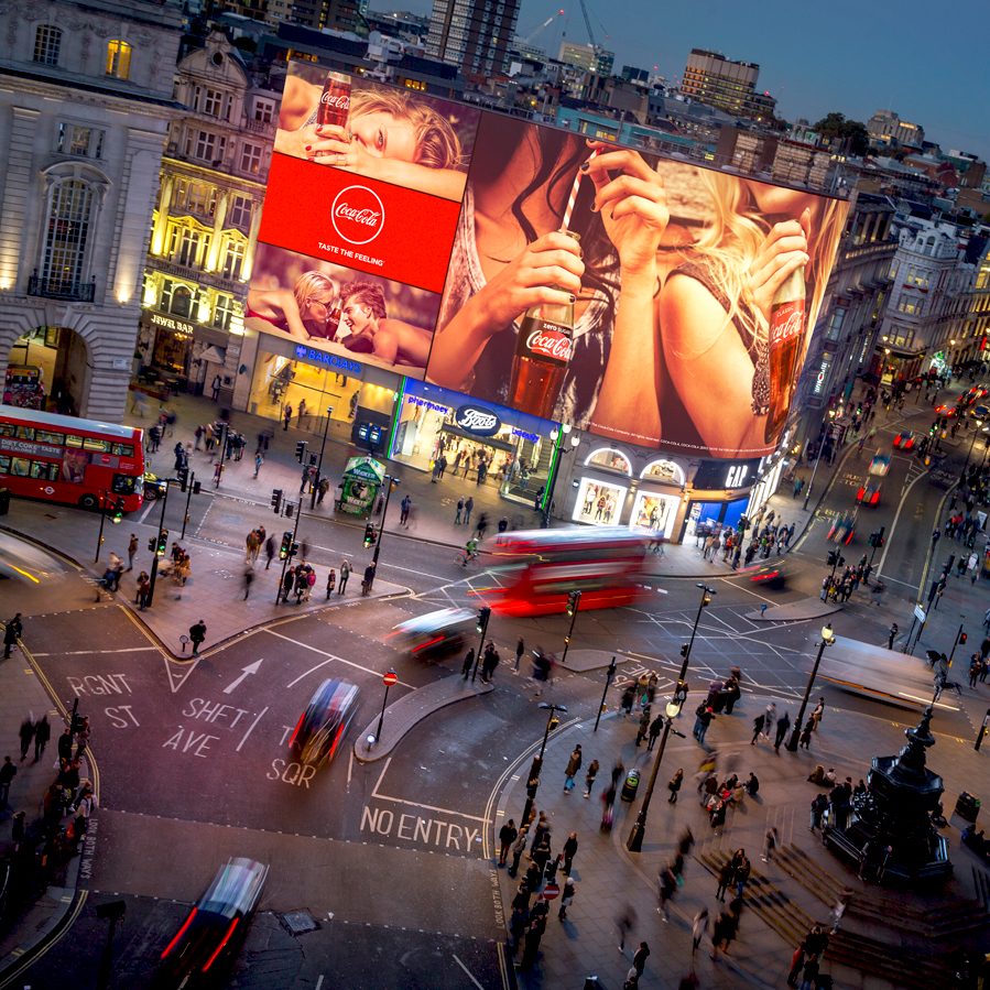 Image shows large digital screens at Piccadilly Circus, London