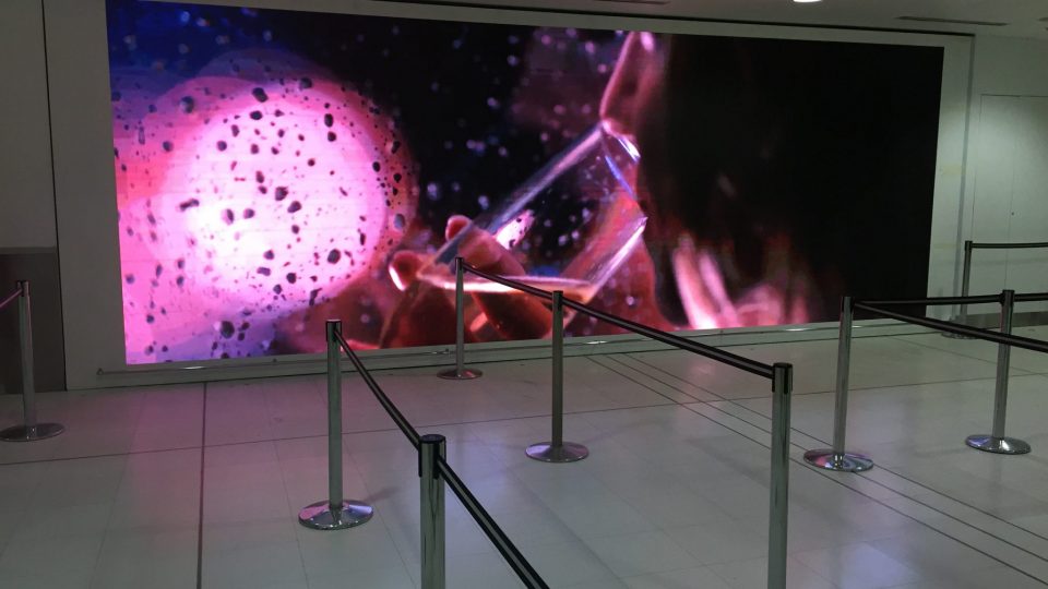 Image shows a large digital screen inside an airport