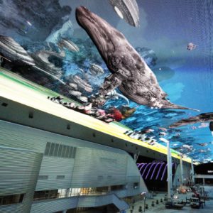 Image shows a large digital screen on the ceiling of a shopping centre, displaying an underwater scene