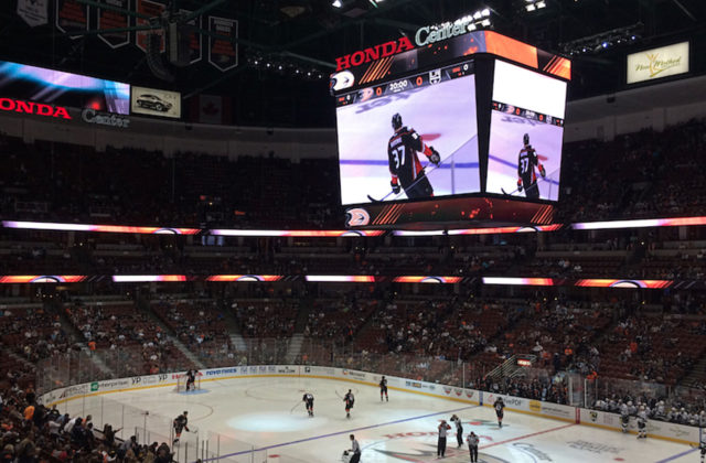 Image shows large screen above ice hockey rink