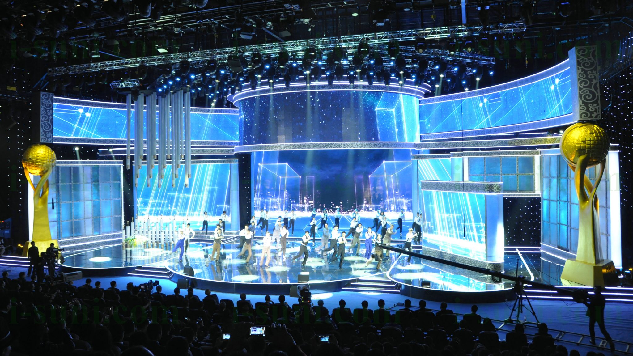 Image shows large digital display screens as the backdrop for a large stage production