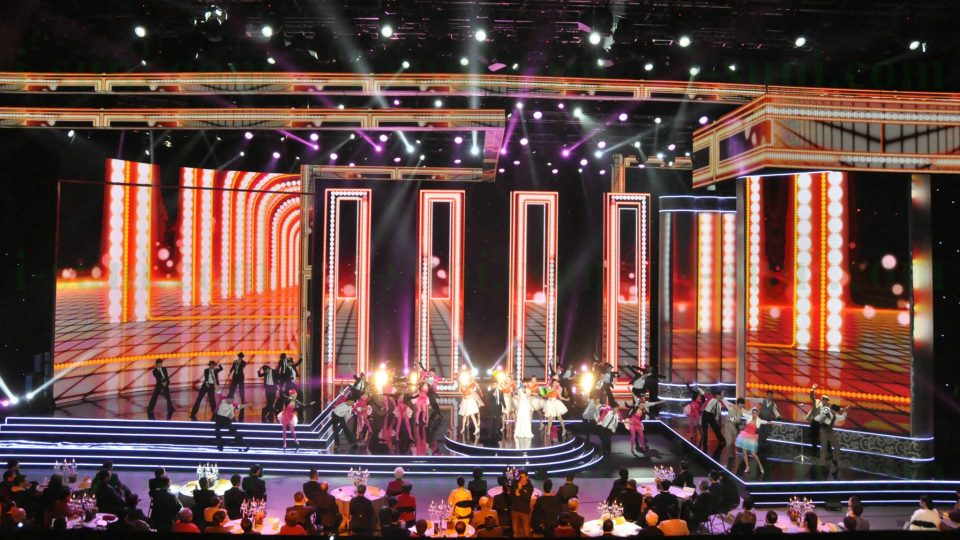 Image shows large display screens as a backdrop to a stage production