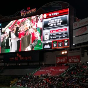 Image shows a large sport stadium scoreboard