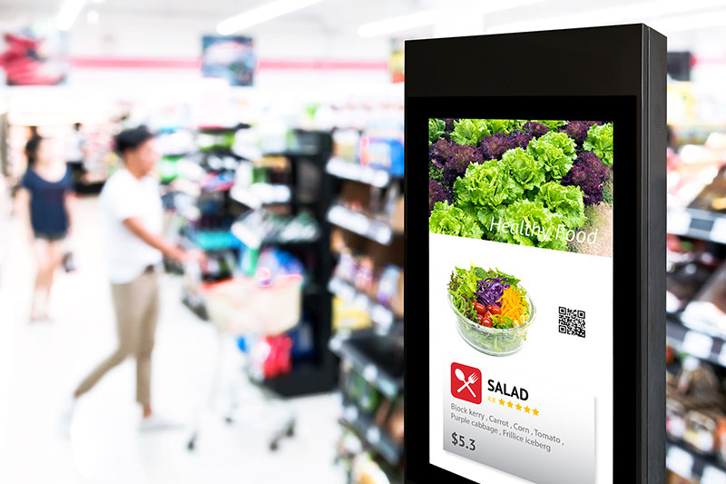Image shows a free standing digital display at a supermarket