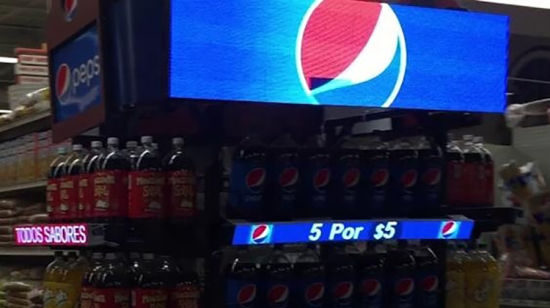 Image shows digital screen on the top of a drinks stand displaying brand logo